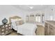 Bright bedroom with arched windows, light wood floors, and a mirrored side table at 9760 E San Salvador Dr, Scottsdale, AZ 85258