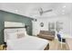 Bedroom with green accent wall, white bedding, recessed lights, fan, and window at 9760 E San Salvador Dr, Scottsdale, AZ 85258