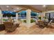 Inviting covered patio with comfortable seating, ceiling fans, and views of the lush backyard and pool at 9760 E San Salvador Dr, Scottsdale, AZ 85258