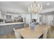 Bright dining area featuring a chandelier, modern tile floors, and a view of the gourmet kitchen at 9760 E San Salvador Dr, Scottsdale, AZ 85258