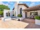 Beautiful home with a tiled roof, covered patio, string lights, and a landscaped courtyard at 9760 E San Salvador Dr, Scottsdale, AZ 85258