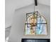 Grand foyer with a decorative stained glass window and modern chandelier at 9760 E San Salvador Dr, Scottsdale, AZ 85258