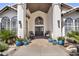 Inviting front porch features double doors and colorful potted flowers, perfect for relaxing at 9760 E San Salvador Dr, Scottsdale, AZ 85258
