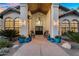 Inviting front porch features double doors and colorful potted flowers, perfect for relaxing at 9760 E San Salvador Dr, Scottsdale, AZ 85258