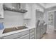 Kitchen featuring stainless steel appliances, white cabinetry, and cooktop at 9760 E San Salvador Dr, Scottsdale, AZ 85258