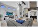 Expansive living room with soaring ceilings, a large sectional sofa, and a decorative ceiling fan at 9760 E San Salvador Dr, Scottsdale, AZ 85258