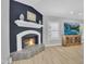 Open-concept living room with fireplace, light colored wood flooring, and a large television at 9760 E San Salvador Dr, Scottsdale, AZ 85258