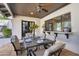 Covered patio with an outdoor dining set and a large window looking into the home at 9760 E San Salvador Dr, Scottsdale, AZ 85258