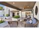Inviting outdoor patio with a ceiling fan, comfortable seating, lush landscaping, and a covered patio at 9760 E San Salvador Dr, Scottsdale, AZ 85258