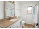 Bright bathroom with granite countertops, a large mirror, and a shower with a floral curtain at 10219 E Le Marche Dr, Scottsdale, AZ 85255