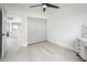 A cozy bedroom with light wood floors, a ceiling fan, and a closet with sliding doors at 10219 E Le Marche Dr, Scottsdale, AZ 85255