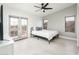 Light-filled bedroom with white flooring, ceiling fan, and French doors leading to a balcony at 10219 E Le Marche Dr, Scottsdale, AZ 85255