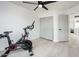 Bright exercise room featuring spin bike, closet, fan and light colored floors at 10219 E Le Marche Dr, Scottsdale, AZ 85255