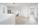 Spacious loft featuring light wood floors, white walls and staircase to lower level at 10219 E Le Marche Dr, Scottsdale, AZ 85255
