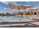 Shallow water pool with sun umbrellas surrounded by lounge chairs at 10219 E Le Marche Dr, Scottsdale, AZ 85255