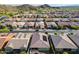 This aerial view showcases a lovely home with a pool, a well-maintained neighborhood, and mountain views at 10260 W Pinnacle Vista Dr, Peoria, AZ 85383