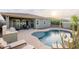Beautiful backyard showcasing a sparkling pool, lounge chairs, and a covered patio at 10260 W Pinnacle Vista Dr, Peoria, AZ 85383