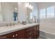 Elegant bathroom with double sinks, framed mirrors, soaking tub, and bright lighting at 10260 W Pinnacle Vista Dr, Peoria, AZ 85383