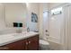 Bright bathroom featuring a modern vanity, a stylish mirror, and a shower-tub combo at 10260 W Pinnacle Vista Dr, Peoria, AZ 85383