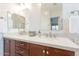 Bathroom featuring a dual sink vanity with chrome fixtures, framed mirrors, and modern lighting at 10260 W Pinnacle Vista Dr, Peoria, AZ 85383