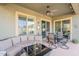 Relaxing covered patio features comfortable seating and a coffee table with convenient access to the home at 10260 W Pinnacle Vista Dr, Peoria, AZ 85383