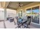 Inviting covered patio with ceiling fan, outdoor furniture, and sliding glass doors at 10260 W Pinnacle Vista Dr, Peoria, AZ 85383