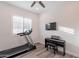 Well-lit home exercise room with a treadmill, keyboard, and sleek design for fitness enthusiasts at 10260 W Pinnacle Vista Dr, Peoria, AZ 85383