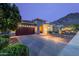 Charming desert home features a paved driveway, two-car garage, and professionally landscaped yard at 10260 W Pinnacle Vista Dr, Peoria, AZ 85383
