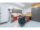 Organized garage featuring ample storage cabinets, workbench, and epoxy flooring at 10260 W Pinnacle Vista Dr, Peoria, AZ 85383