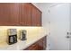 Kitchen with brown cabinetry and quartz countertops, as well as stainless steel appliances at 10260 W Pinnacle Vista Dr, Peoria, AZ 85383