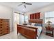 Comfortable main bedroom with wood furnishings, sliding barn door, and plenty of natural light at 10260 W Pinnacle Vista Dr, Peoria, AZ 85383