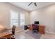 Cozy home office with natural light, ceiling fan, and wood furnishings at 10260 W Pinnacle Vista Dr, Peoria, AZ 85383