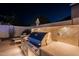 This outdoor kitchen has beautiful travertine tile, a built-in barbeque, and plenty of counter space at 10260 W Pinnacle Vista Dr, Peoria, AZ 85383
