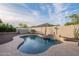 Private backyard featuring a freeform pool with surrounding desert landscaping at 10260 W Pinnacle Vista Dr, Peoria, AZ 85383