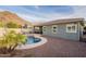 Inviting backyard pool, outdoor kitchen, and mountain views create the perfect place for relaxing and entertaining at 10260 W Pinnacle Vista Dr, Peoria, AZ 85383