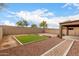 Backyard featuring desert landscaping, block fence, and covered patio at 10835 W Saddlehorn Rd, Peoria, AZ 85383