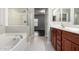 Bathroom featuring a glass enclosed shower, soaking tub, and double sink vanity at 10835 W Saddlehorn Rd, Peoria, AZ 85383