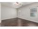 Spacious bedroom featuring hard wood floors and natural light from two windows at 10835 W Saddlehorn Rd, Peoria, AZ 85383