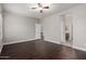 Spacious bedroom featuring a ceiling fan, wood floors, and ensuite bathroom at 10835 W Saddlehorn Rd, Peoria, AZ 85383