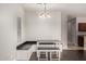 Dining area features a built in bench, table and view of kitchen and window at 10835 W Saddlehorn Rd, Peoria, AZ 85383