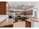 Well-equipped kitchen featuring wood cabinets, stainless steel appliances, and tile flooring at 10835 W Saddlehorn Rd, Peoria, AZ 85383