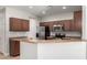 Well-equipped kitchen featuring wood cabinets, stainless steel appliances, and tile flooring at 10835 W Saddlehorn Rd, Peoria, AZ 85383
