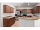 Well-equipped kitchen featuring wood cabinets, stainless steel appliances, and tile flooring at 10835 W Saddlehorn Rd, Peoria, AZ 85383