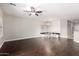 Open living space with dining area, dark wood floors, and ceiling fan at 10835 W Saddlehorn Rd, Peoria, AZ 85383