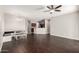 Open living space with dark wood floors, a ceiling fan, and views into the kitchen at 10835 W Saddlehorn Rd, Peoria, AZ 85383