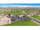 Aerial view of Sunland Springs Golf Club showcasing the course, clubhouse, parking, and surrounding desert landscape at 10960 E Monte Ave # 169, Mesa, AZ 85209