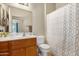 Well-lit bathroom features a single vanity and a shower with a patterned curtain at 10960 E Monte Ave # 169, Mesa, AZ 85209