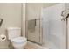 Clean bathroom featuring a white toilet, tiled shower with safety bar and a glass door at 10960 E Monte Ave # 169, Mesa, AZ 85209