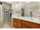 Spacious bathroom features a double vanity, large mirror, and adjacent walk-in closet at 10960 E Monte Ave # 169, Mesa, AZ 85209
