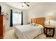 Cozy bedroom with ceiling fan, natural light, and decorative quilt at 10960 E Monte Ave # 169, Mesa, AZ 85209